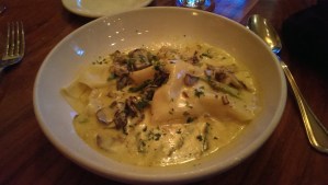 Lobster ravioli with asparagus and local mushrooms, with brandy, saffron and cream.